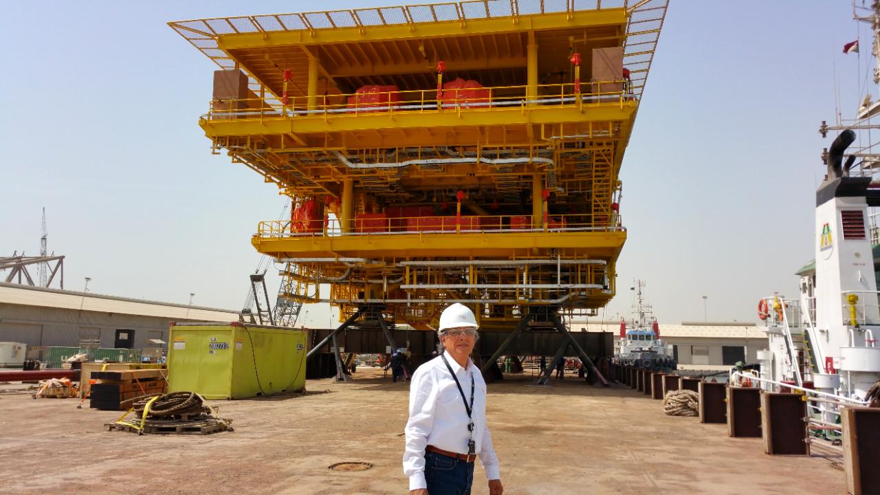 Marcelo Robles in front of a yellow offshore topside deck at the Aramco STAR Yard, Wasit Gas Program